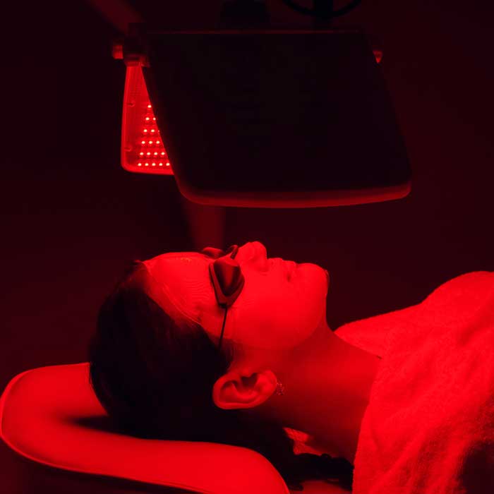 Woman having a LED Red Light Therapy by Natalie's Skin Solutions